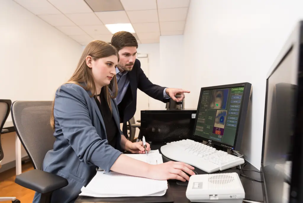 researchers reviewing data on computer